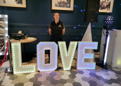 colour picture of Mighty Fozzy Entertainment light up LOVE letters with model for size reference